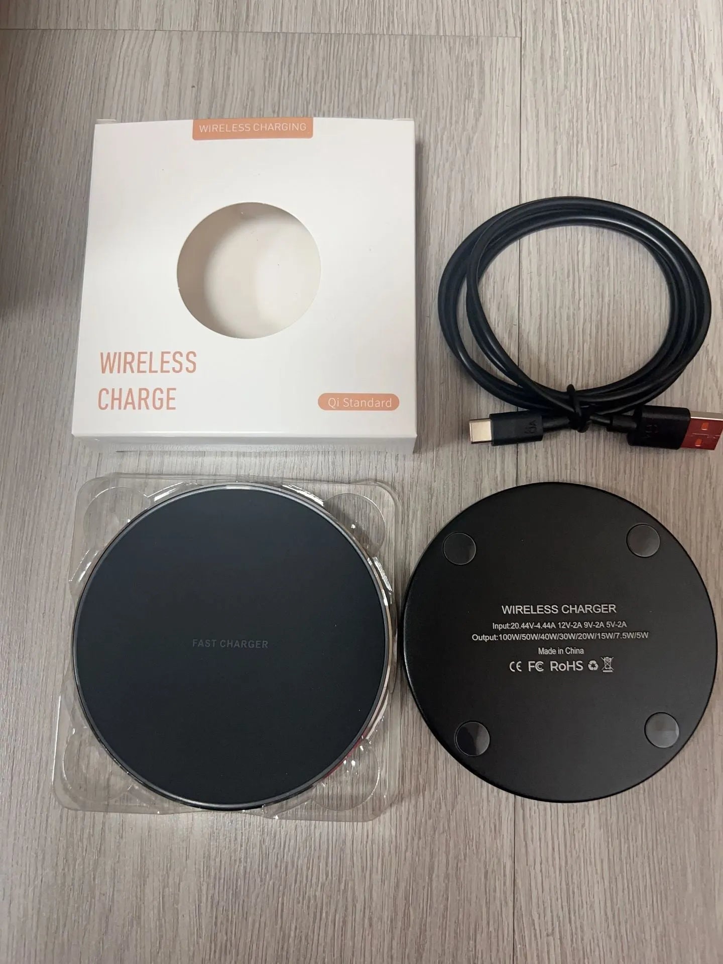 Black frosted 15W wireless charger on a desk with a Type-C cable connected