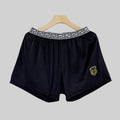 Men's solid colour knitted polyester boxer shorts in black, loose fit mid-waist breathable design, available in sizes L to 4XL