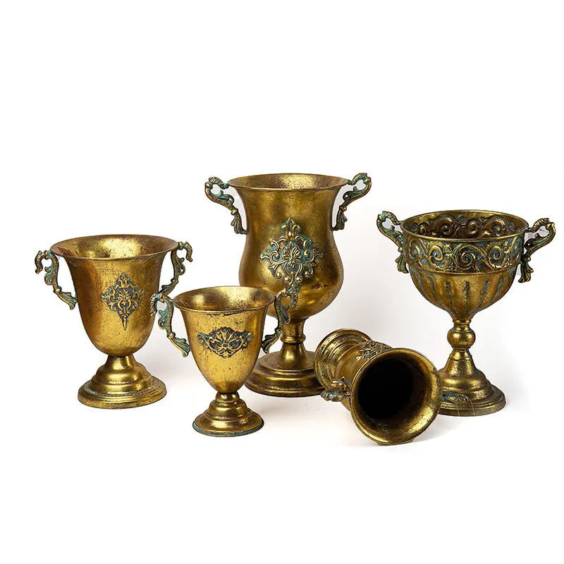 Metal decorative vase with black and gold finish, modern simplicity design on a tabletop