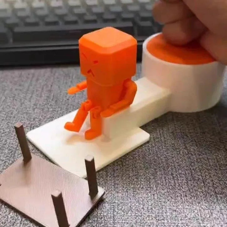 Orange plastic vent-themed table spinning decompression fidget toy on a desk.
