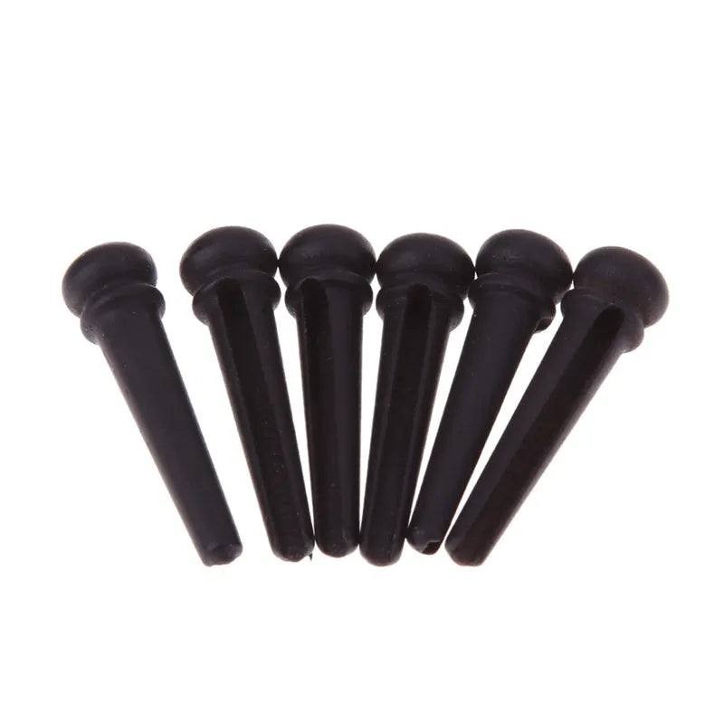 Six matte black ebony guitar bridge pins with a 5.3mm bayonet for folk acoustics.