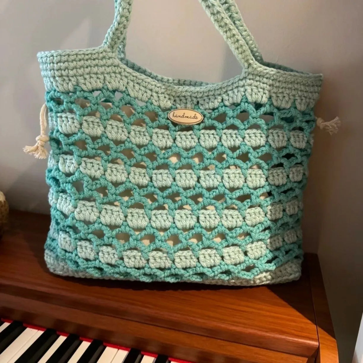 Handwoven wool floral handbag in summer style with natural pattern