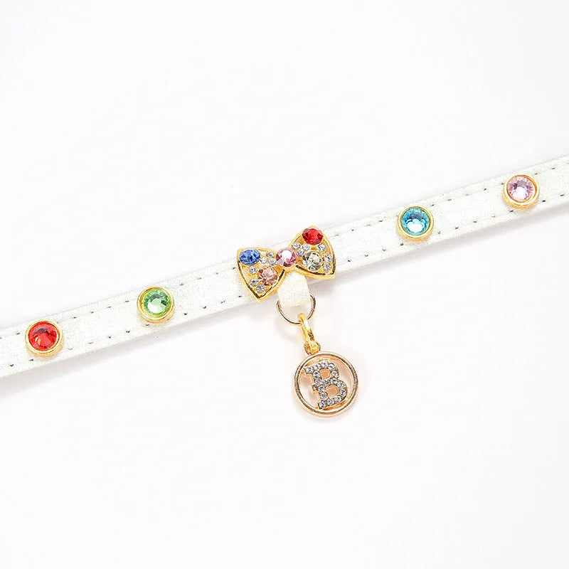 White PU cat collar with diamond alloy bow on a flat surface showing buckle and bow detail