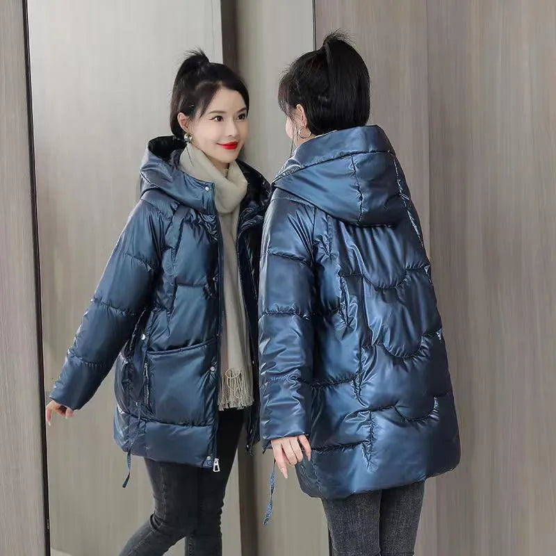 Woman wearing a loose-fit green hooded winter jacket with long sleeves.