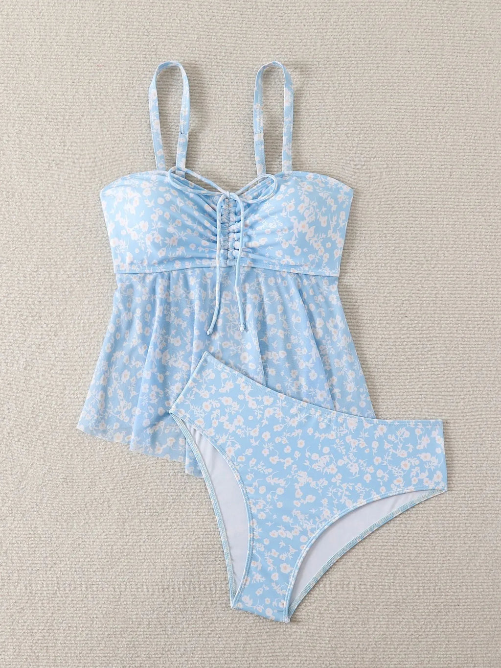 Light blue floral women's swimsuit set with shoulder straps and backless design, available in sizes S to XL
