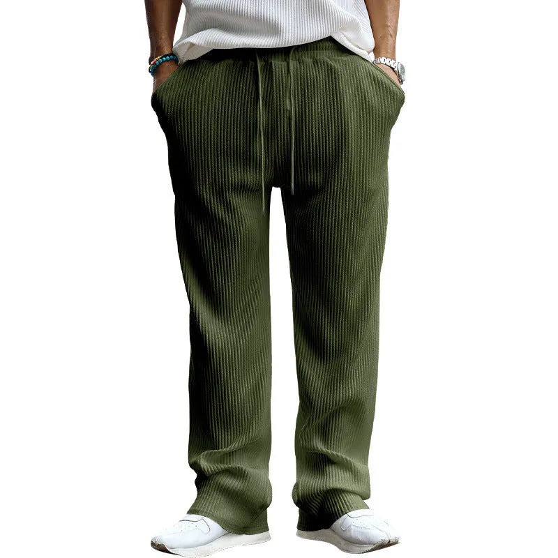 Man wearing loose high-waist striped casual trousers in Army Green, showing the straight leg fit.