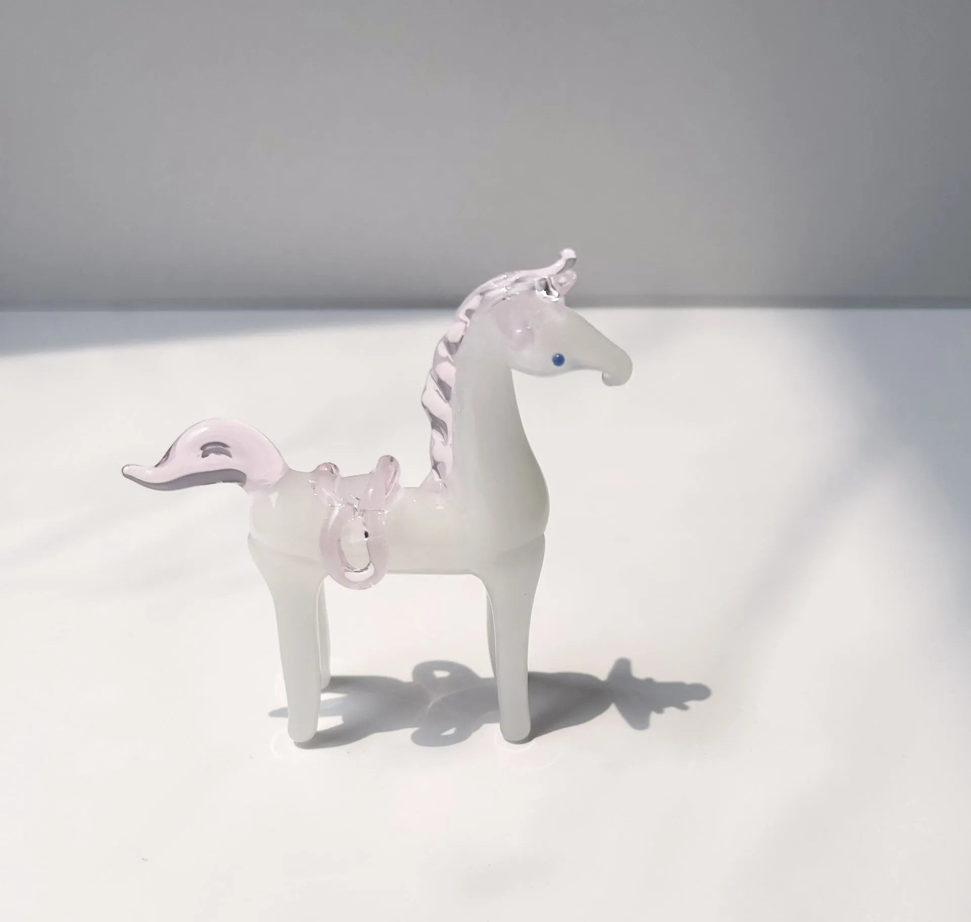 Glazed brown horse figurine on wooden desk as office decoration