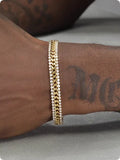 Gold tennis bracelet for men and women with titanium steel construction and gemstone inlays.