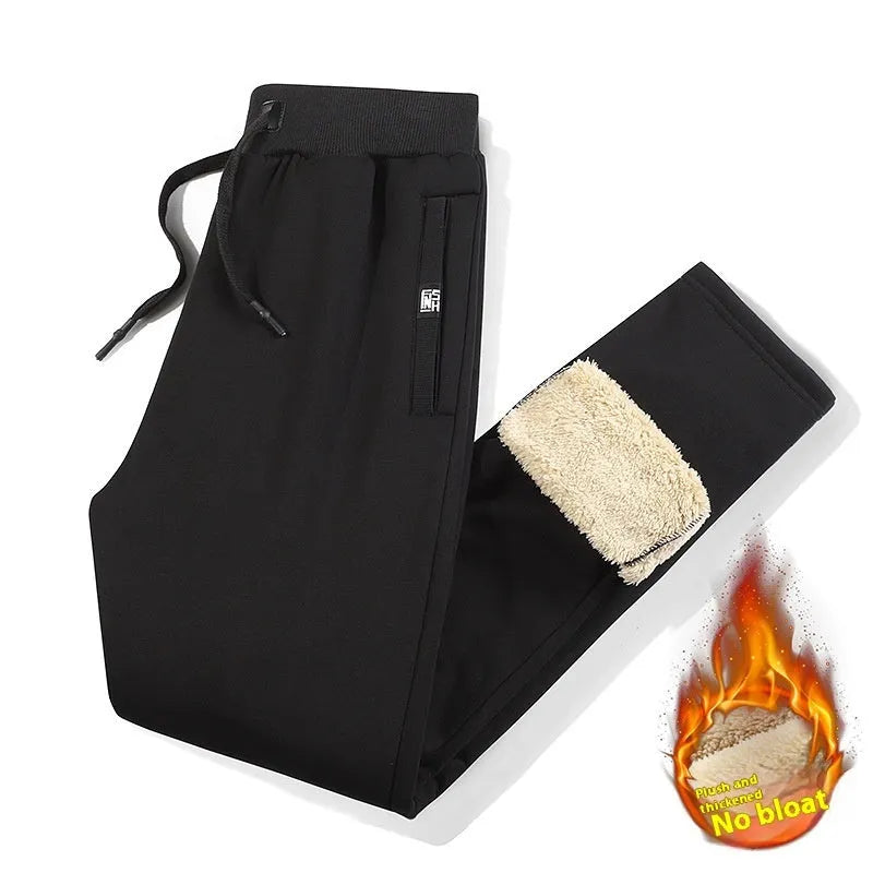 Men's grey fleece-lined cotton oversized track pants on a hanger, showing mid waist and straight leg.