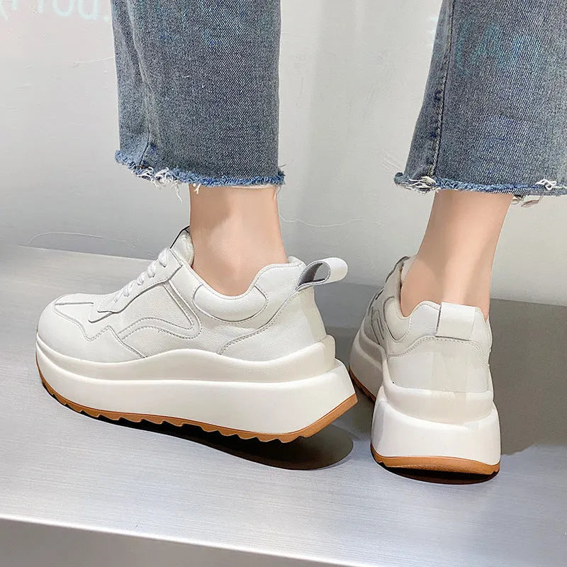 Beige women's leather casual sports shoes with low top, round toe, lace-up closure, and cross strap detail