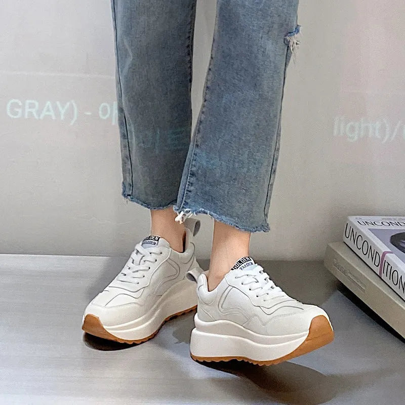 Beige women's leather casual sports shoes with low top, round toe, lace-up closure, and cross strap detail
