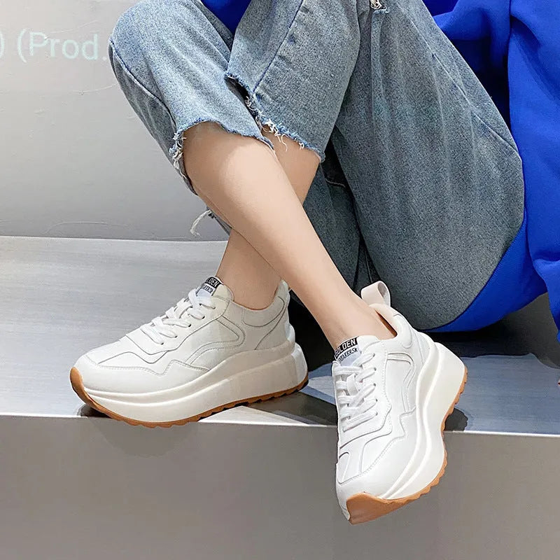Beige women's leather casual sports shoes with low top, round toe, lace-up closure, and cross strap detail