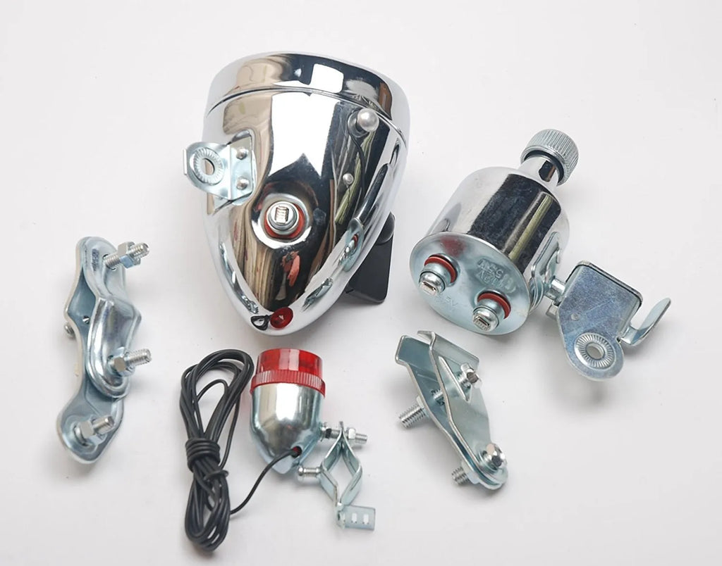 Silver bicycle dynamo generator light kit mounted on a bike frame with front and rear lights