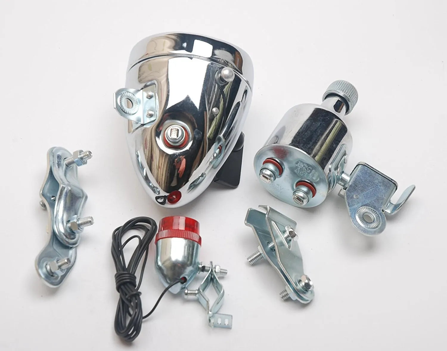 Silver bicycle dynamo generator light kit mounted on a bike frame with front and rear lights