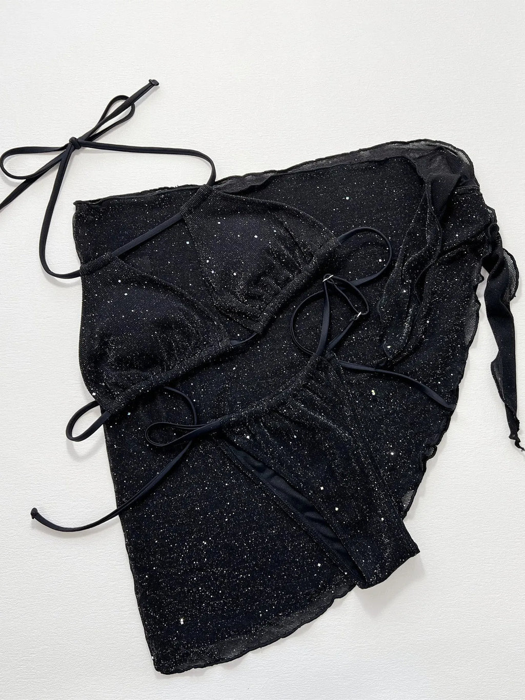 Black three-piece polyester bikini swimsuit set showing top and shorts.