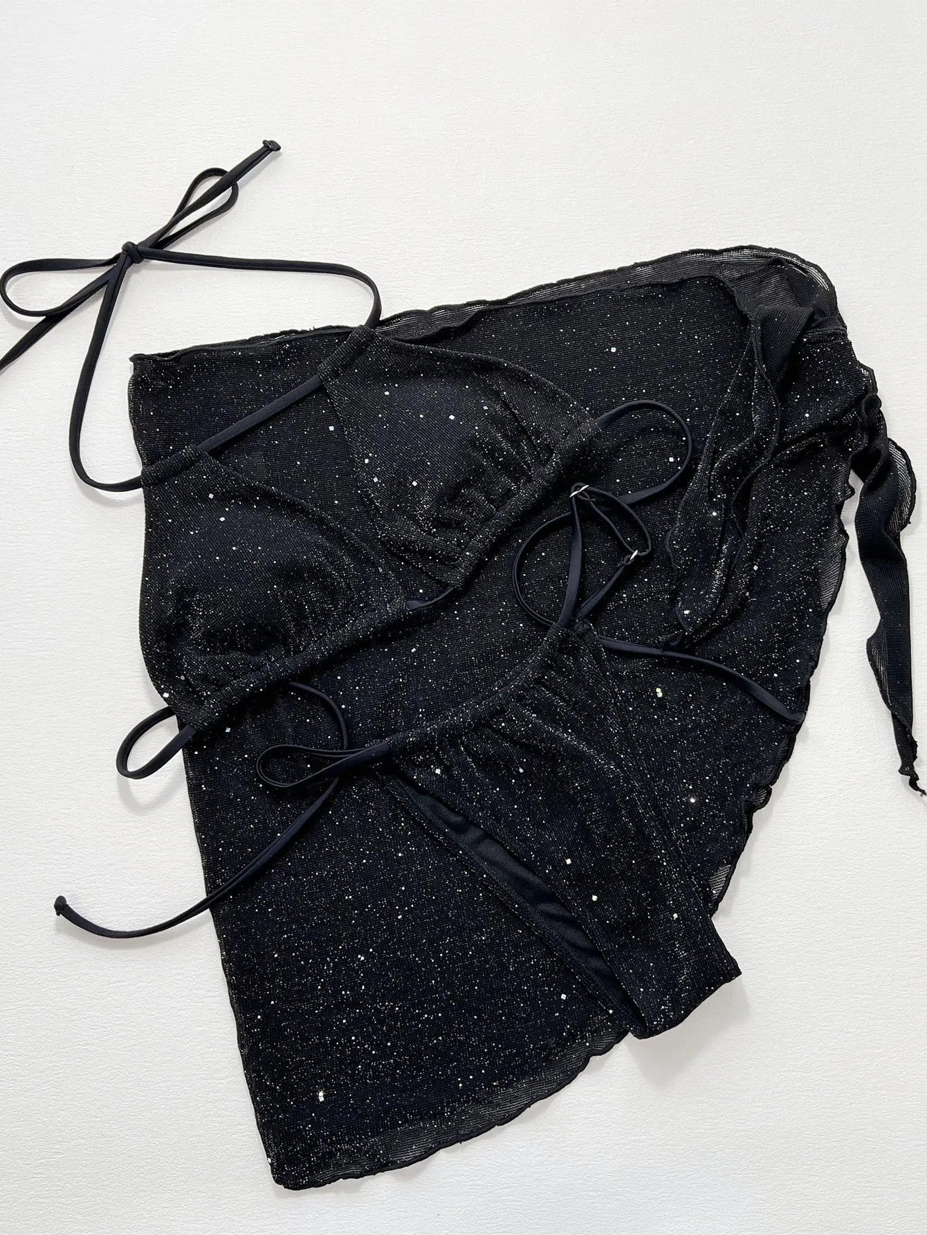 Black three-piece polyester bikini swimsuit set showing top and shorts.
