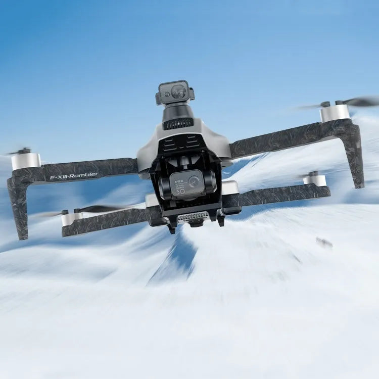 White folding quadcopter drone with camera, remote control, and shoulder bag on a table.