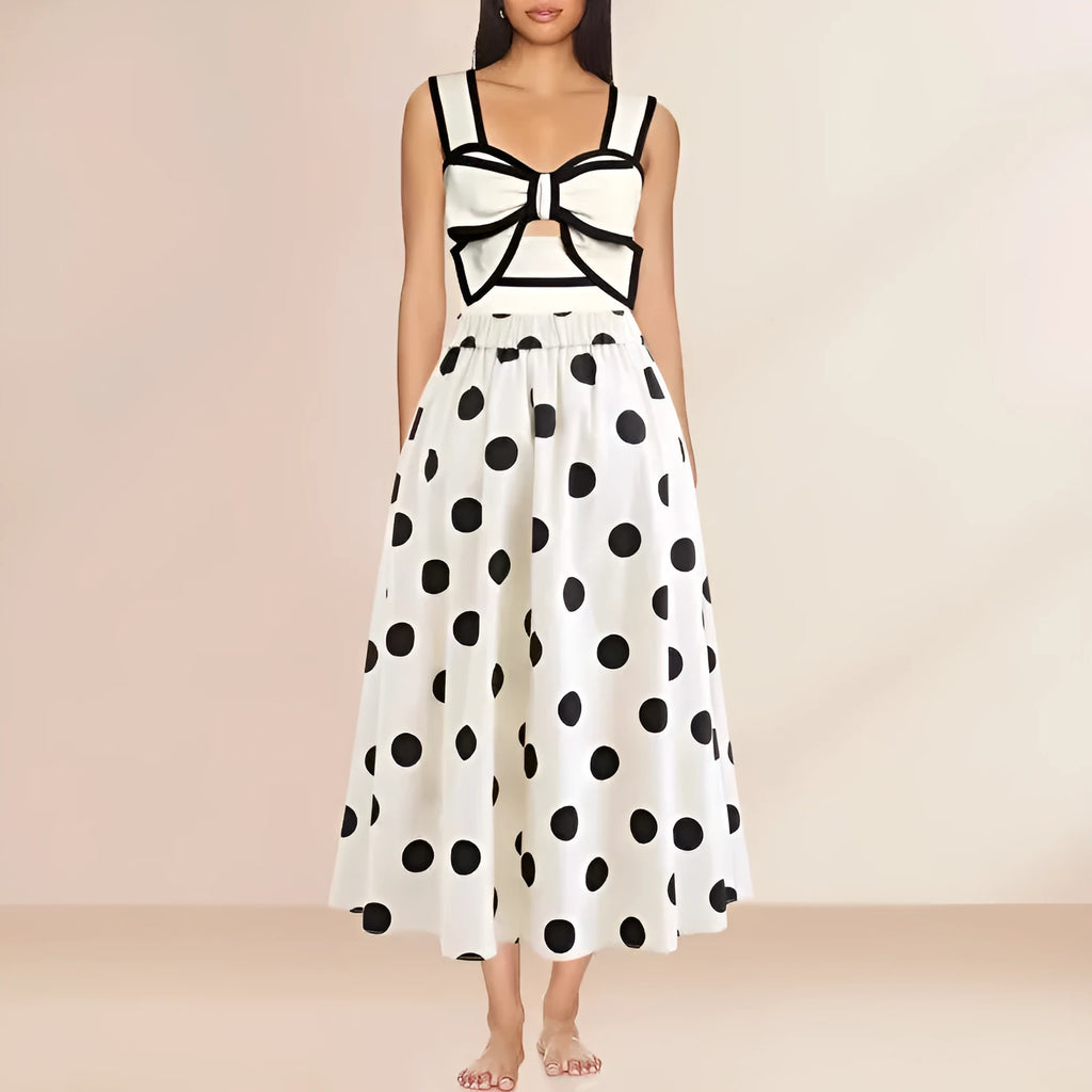 A black one-piece swimsuit for women with a white detachable skirt and a decorative bow at the front.