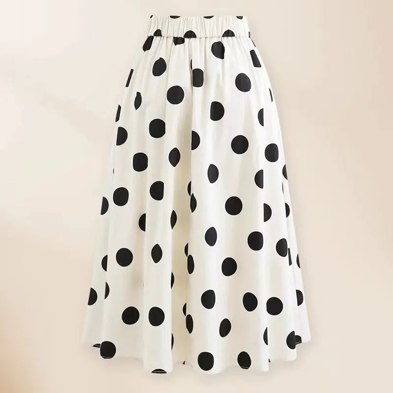 A black one-piece swimsuit for women with a white detachable skirt and a decorative bow at the front.