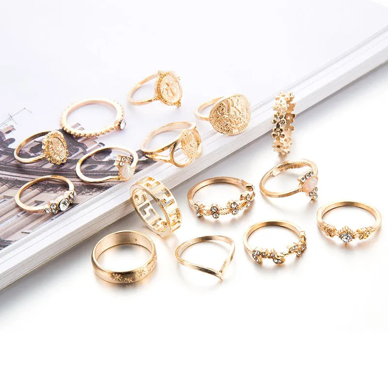 12-piece cross ring set in gold alloy on a flat surface, showing one size design