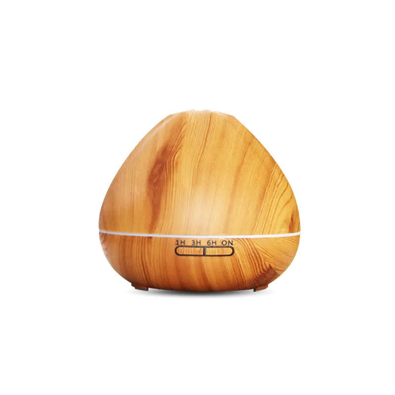 Air humidifier aromatherapy machine with 500ml capacity in dark wood finish on a table