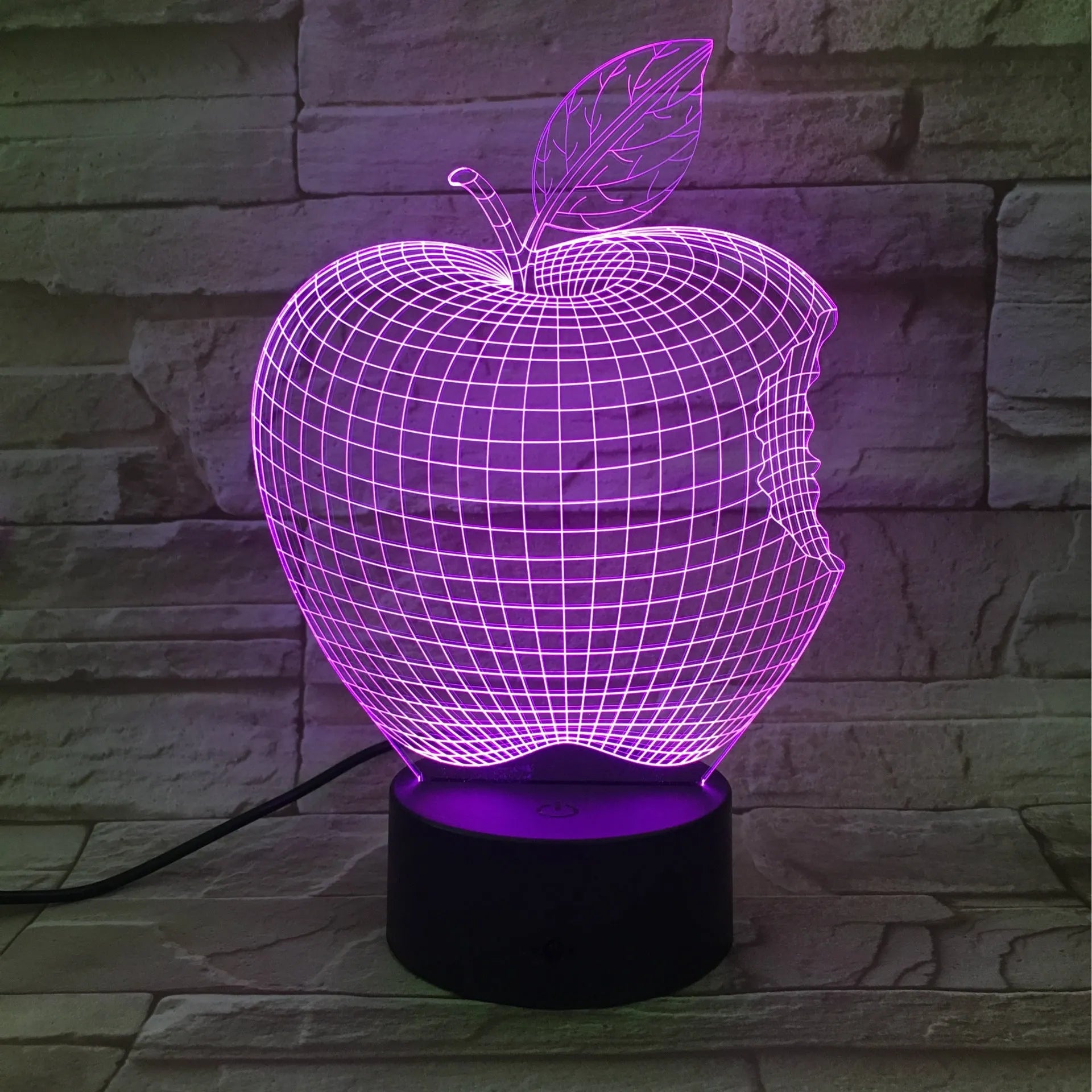 3D fruit-shaped colourful night light with acrylic shade and touch control on a dark surface