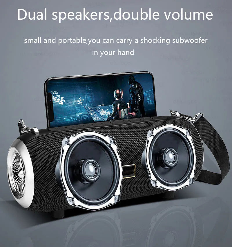 Square fabric portable Bluetooth speaker with FM antenna, shoulder strap, and phone stand groove.
