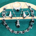 Four-piece bridal jewellery set showing zirconium alloy necklace, earrings, ring, and bracelet in water wave chain design.