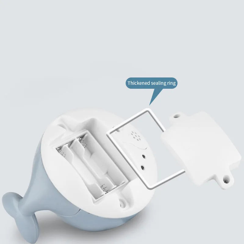 Automatic water-sensing whale bath toy with spray, lights, and music functions for baby bath time