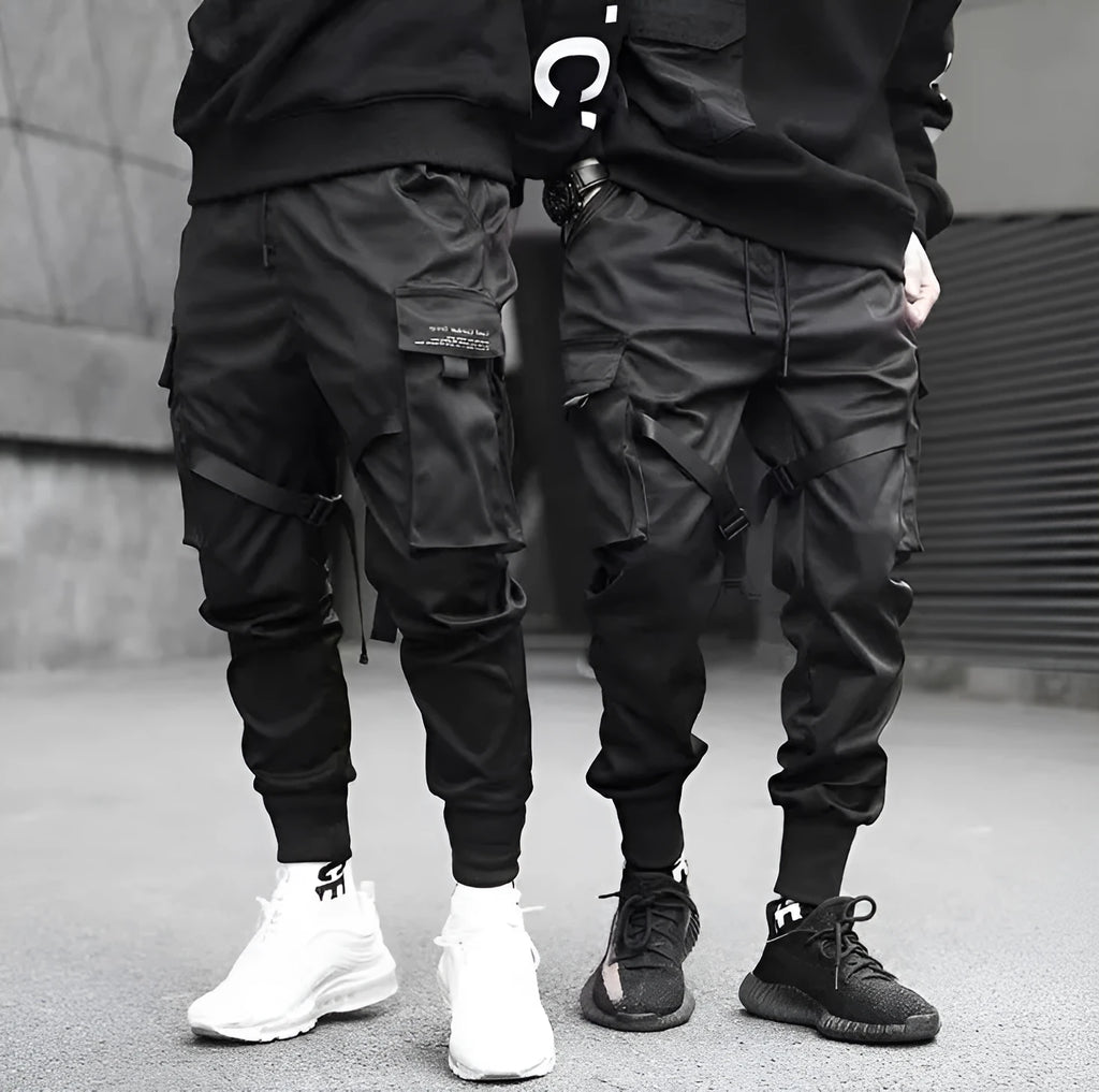 Men's black cotton harem joggers with side pockets and elastic waist, shown with drawstring and Velcro closures