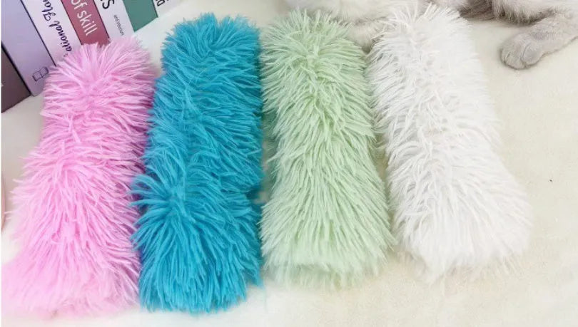 A blue plush cat toy pillow measuring 27cm long on a white background.