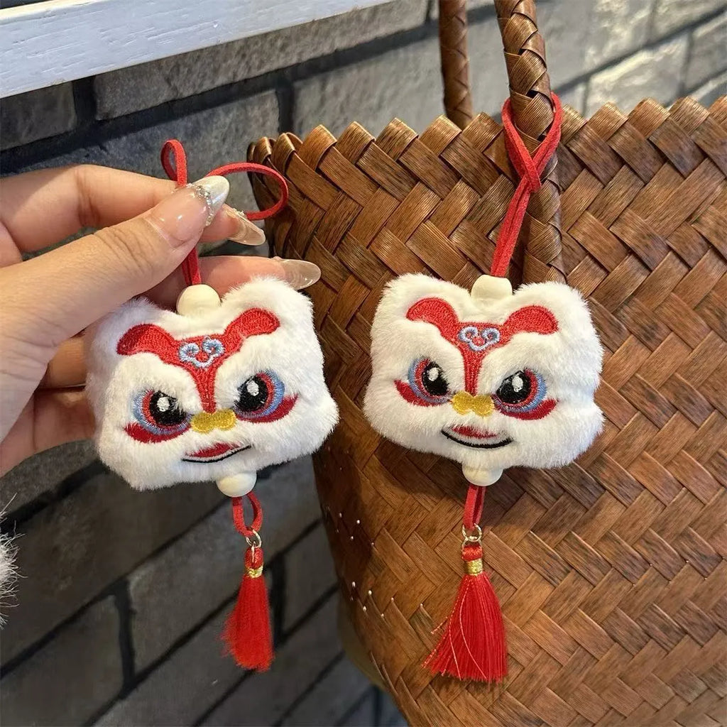 Handmade blue and yellow Chinese style plush lion keychain ornament with star stone decoration.
