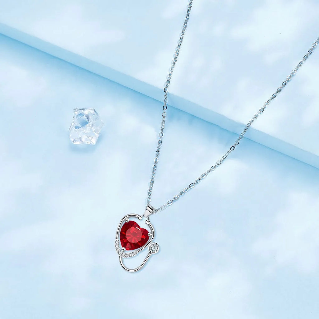 Women's copper stethoscope necklace with red diamond colour pendant on model