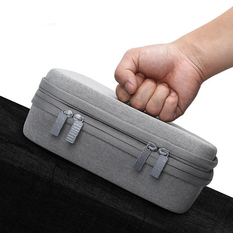 Simple modern black EVA digital storage bag for headphones and cables on a desktop
