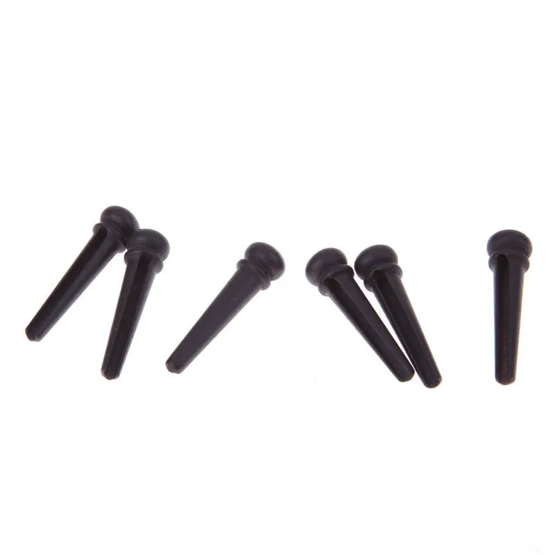 Six matte black ebony guitar bridge pins with a 5.3mm bayonet for folk acoustics.