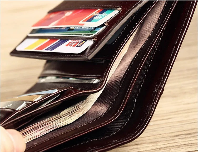Men's leather wallet showing internal compartments for banknotes, cards, coins, and documents