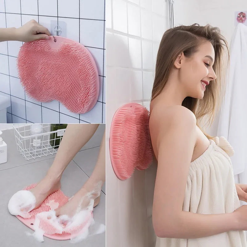 Orange TPR bath brush with silicone bristles and suction cups on base, shown on bathroom tiles.