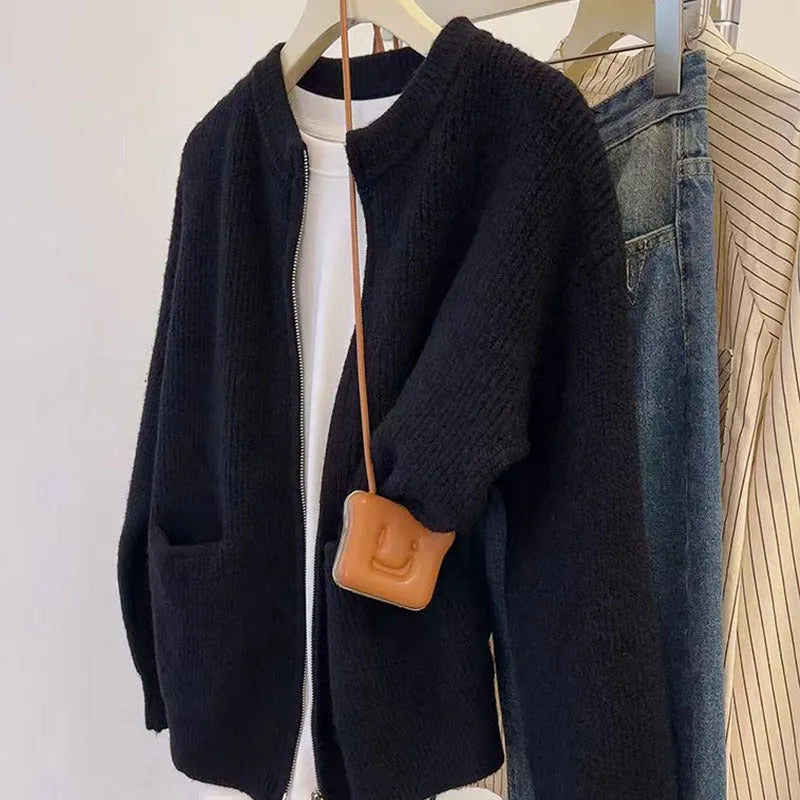 Beige women's long sleeve soft glutinous sweater coat cardigan laid flat.
