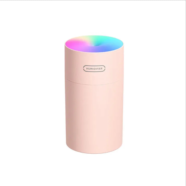 Pink USB desktop humidifier with colourful LED lights and 300ml water tank on wooden desk