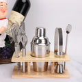 8pc stainless steel cocktail shaker set with graduated pieces on a table, various heights from 11cm to 18cm