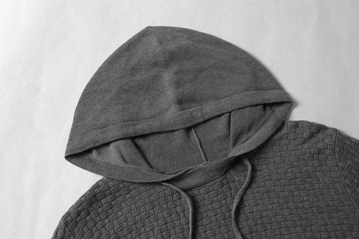 Men's black cotton-polyester blend hooded sweatshirt on a hanger, showcasing the front hood and kangaroo pocket.