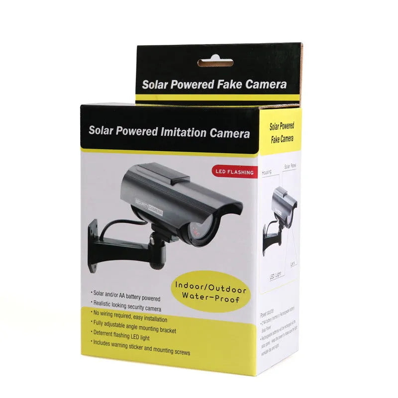 Solar-powered fake security camera in black finish mounted on a wall outdoors
