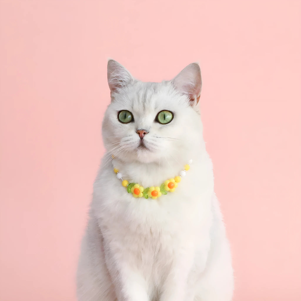 Colourful plastic bead cat necklace in small flower, rainbow, or peach design on adjustable cord.