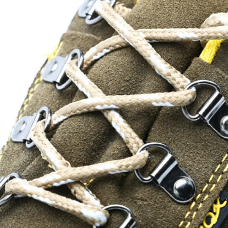 Bronze coloured leather safety boots with steel toe cap on a work site background