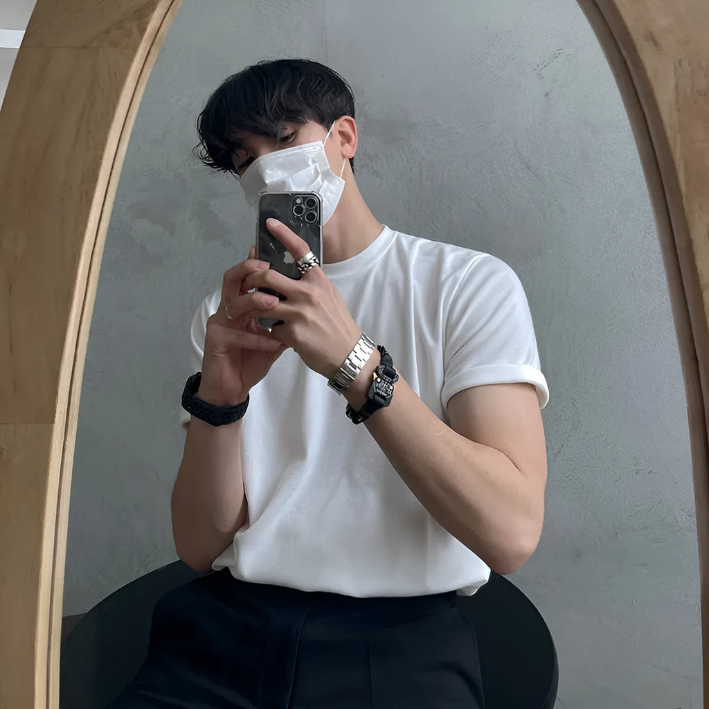 Men's slim fit black cotton t-shirt with round neck and half sleeves on a hanger