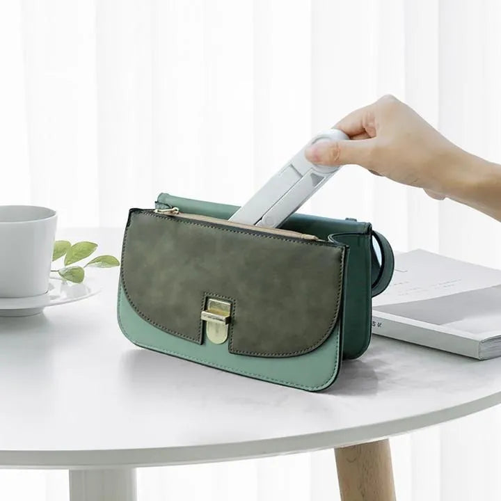 Foldable tablet holder shown in black with smartphone mounted in landscape orientation