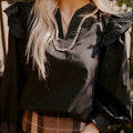Black women's blouse with V-neck, contrast stitching and long ruffle sleeves