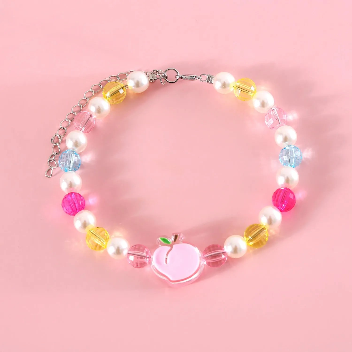 Colourful plastic bead cat necklace in small flower, rainbow, or peach design on adjustable cord.