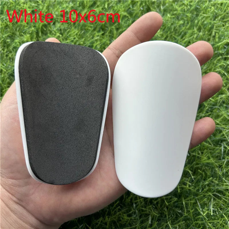 Extra small mini football shin guards measuring 8x5cm in black and white colours