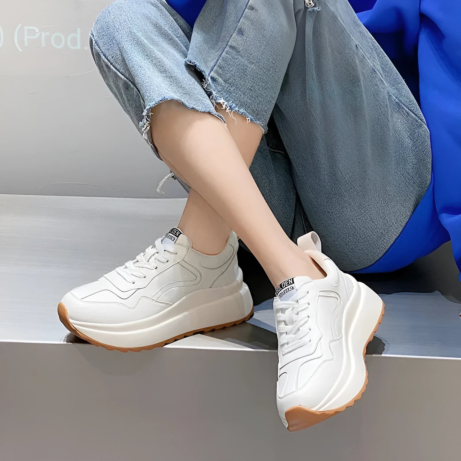 Beige women's leather casual sports shoes with low top, round toe, lace-up closure, and cross strap detail